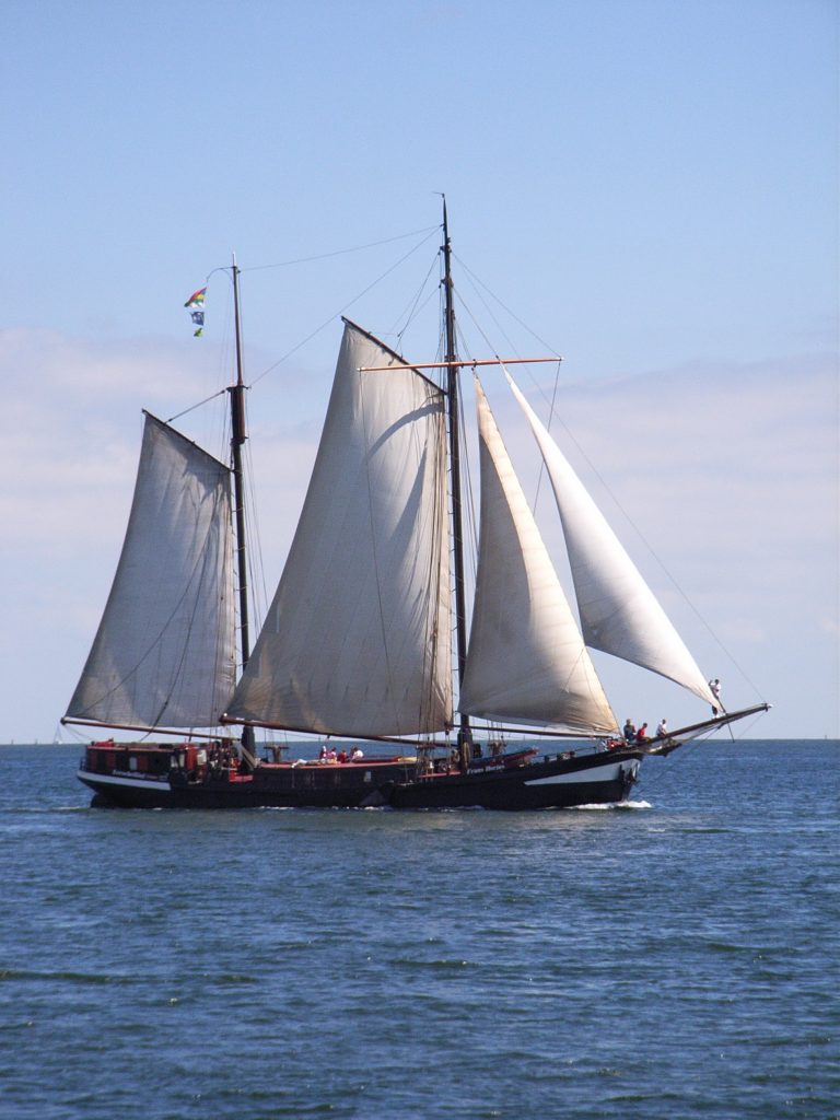 Het historische zeilschip Frans Horjus, een tweemaster, op zee met de wind vol in de zeilen.